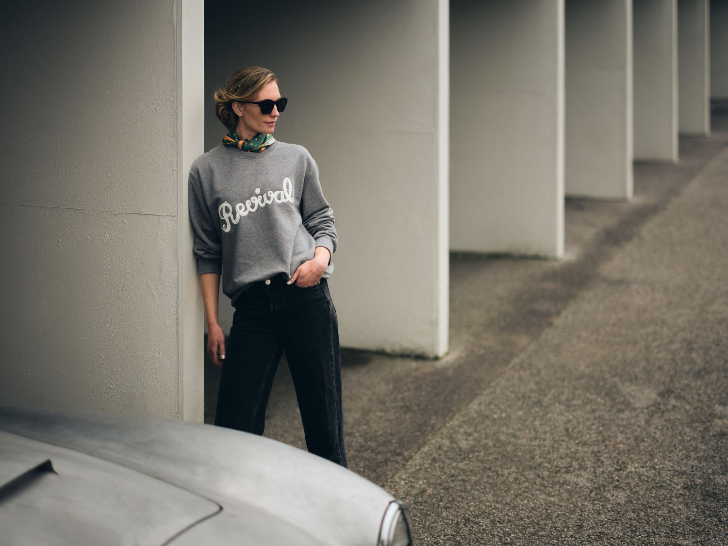 Model at Goodwood Motor Circuit pits, wearing Revival sweatshirt