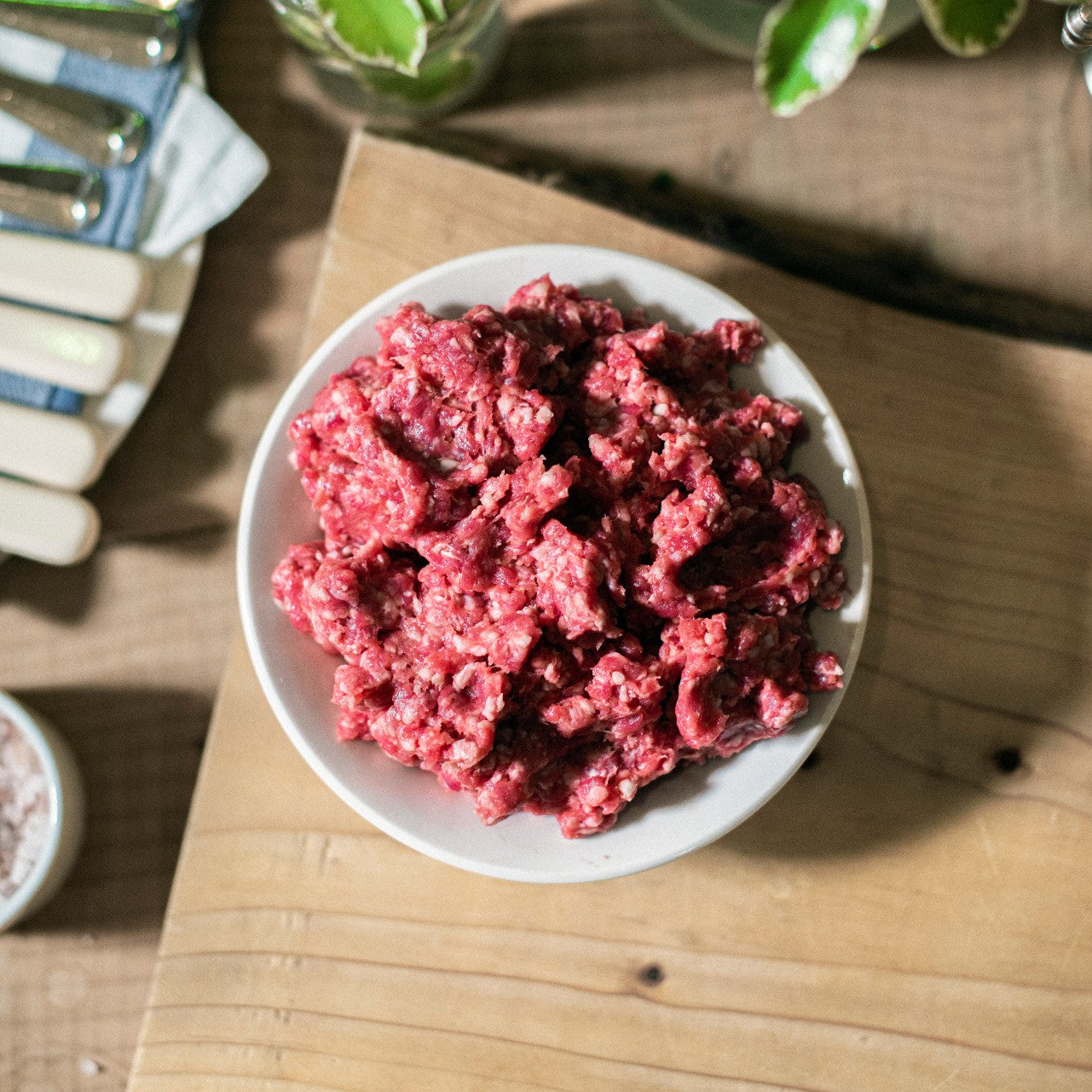 A bowl of organic grass-fed Sussex beef mince, placed on a chopping board at Goodwood Farm Shop.