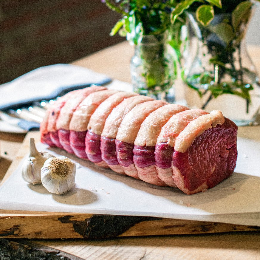 Organic grass-fed Sussex beef silverside roasting joint displayed on a chopping board at the Goodwood Farm Shop.