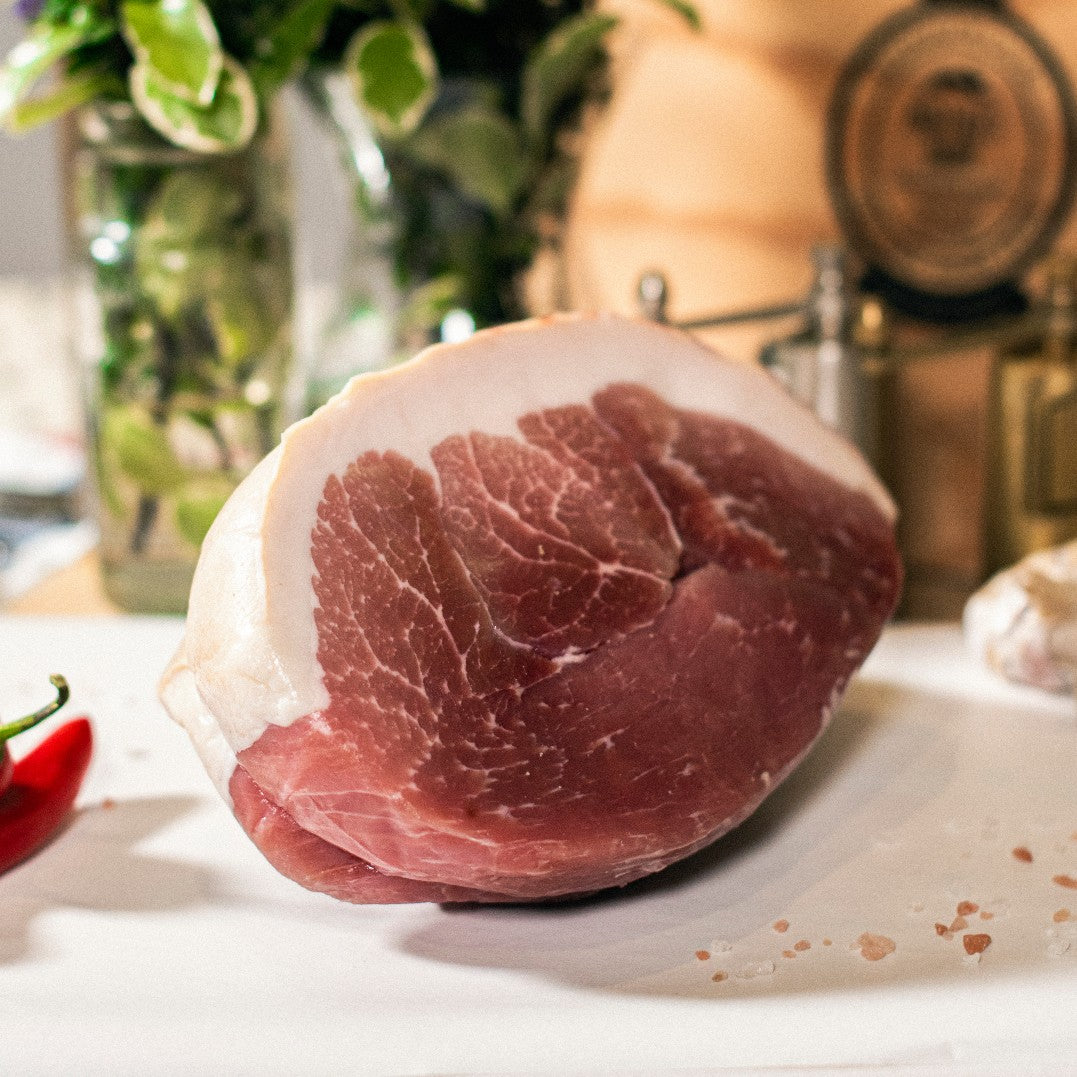 Goodwood's organic gammon pork joint shown on a chopping board at Goodwood Farm Shop. 