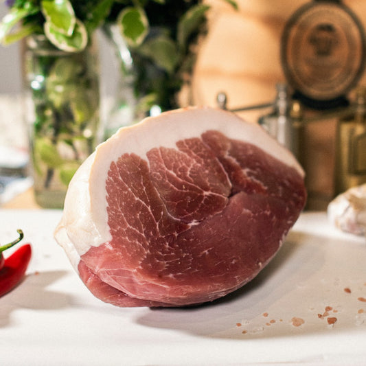 Goodwood's organic gammon pork joint shown on a chopping board at Goodwood Farm Shop.