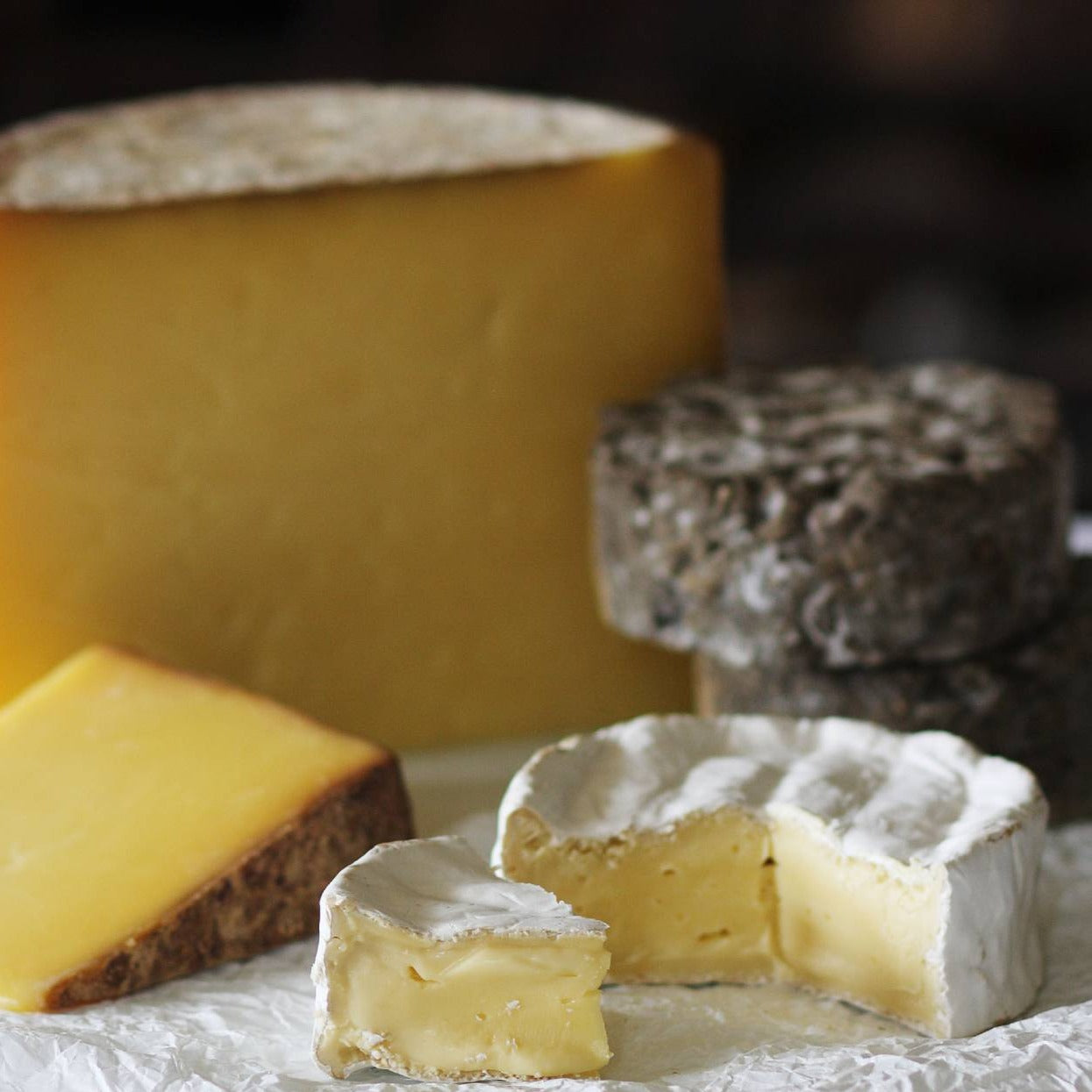 Close up of the Goodwood Cheese Board Trio, containing Goodwood's handmade mature Charlton Cheese, Levin Down and Molecomb Blue.