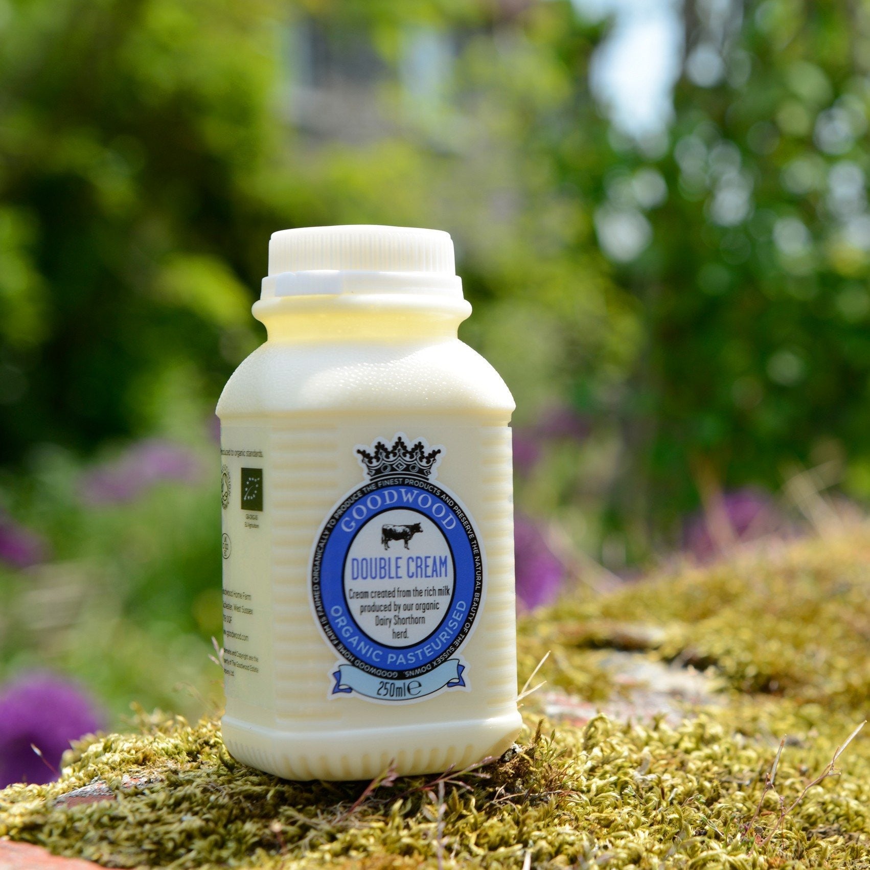 A bottle of 250ml Goodwood Organic Double Cream outside at the Goodwood Farm Shop.