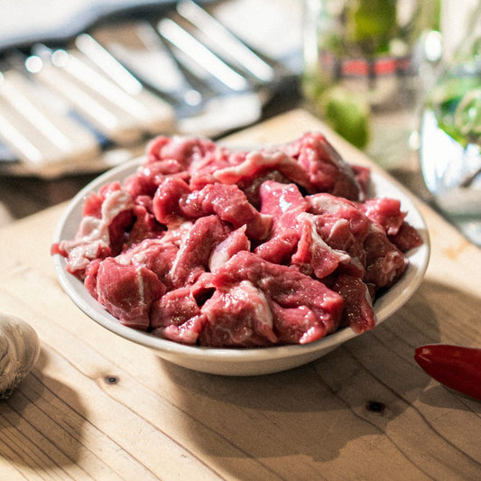 A close up of a bowl containing organic grass-fed lamb, diced ready for cooking, taken at the Goodwood Farm Shop.