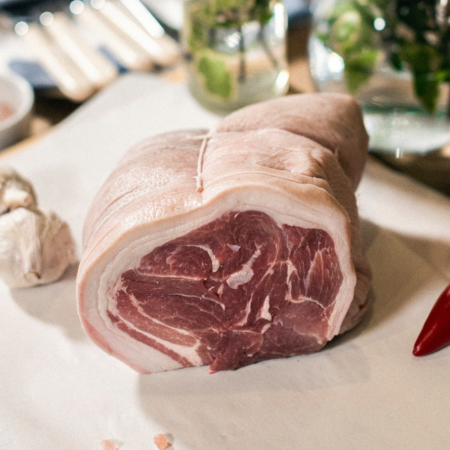 A close up of Goodwood's organic grass-fed boned and rolled pork shoulder joint, available at the Goodwood Farm Shop.