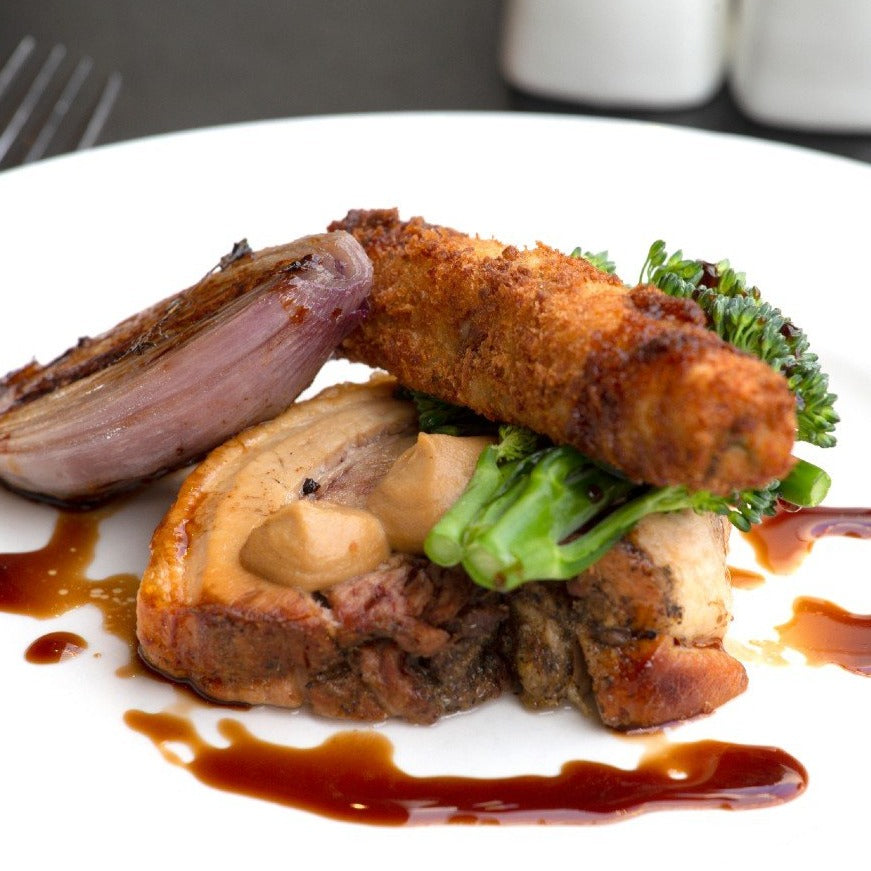 An organic pork loin chop recipe served with potato croquette and broccoli at the Goodwood Bar and Grill restaurant.